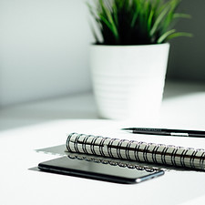 Pen, notebook, and smartphone on the table