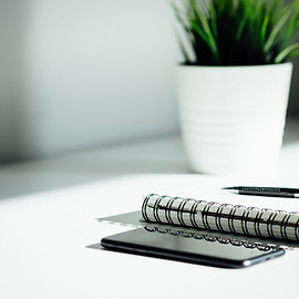 Pen, notebook, and smartphone on the table