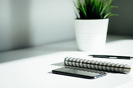 Pen, notebook, and smartphone on the table