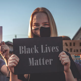 Women holding signs at rally.