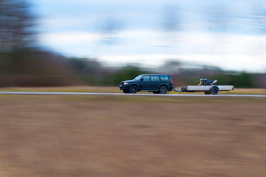 SUV with a trailer and a damaged motorcycle