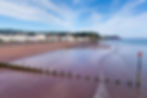 Teignmouth beach Devon England UK with blue sky