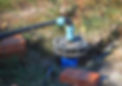 Outdoor water pump system and pipework installed in a grassy area