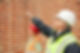 workers in hard hats and safety vests inspecting site