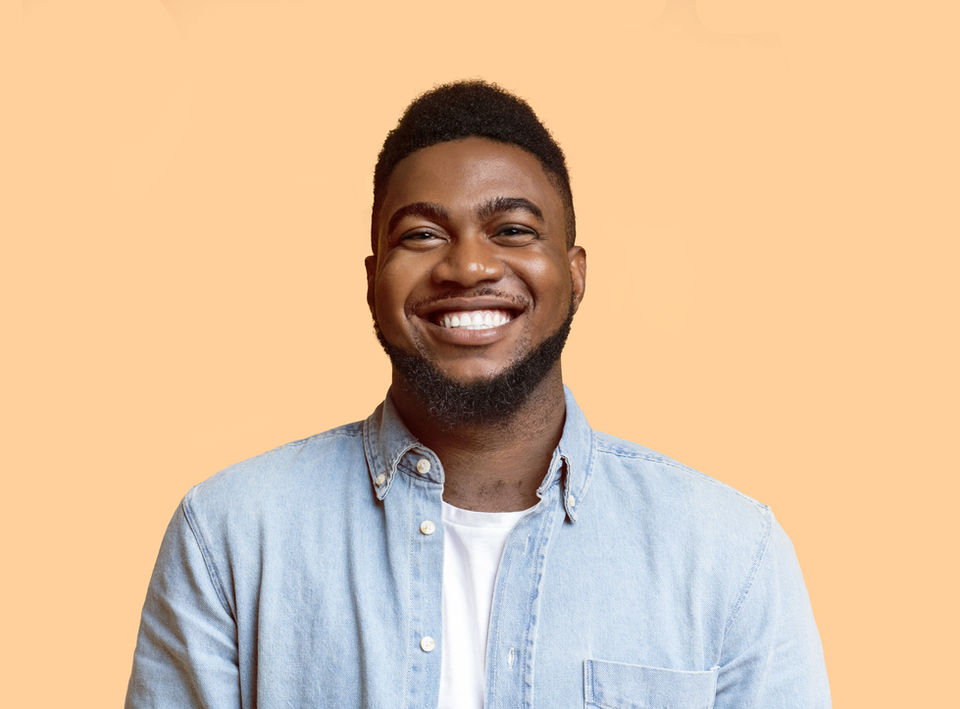 A happy patient proudly showing off his new smile — thrilled with the results of his dental work and grateful to his dentist for the transformation.