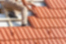 worker installing roof tiles