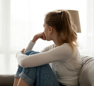 Worried woman on couch