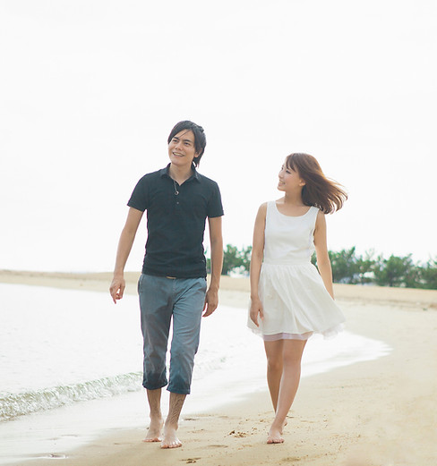 two young people walking on a beach and contemplating the meaning of life