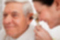 Doctor examining senior patient's ear