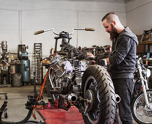 Mechanic Repairing Motorcycle
