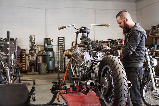 Mechanic Repairing Motorcycle