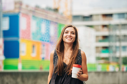 Person holding a cup and smiling