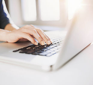 Woman Typing at a computer for technical writing