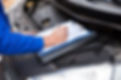 Close-up view of the mechanic filling checklist after vehicles safety inspections