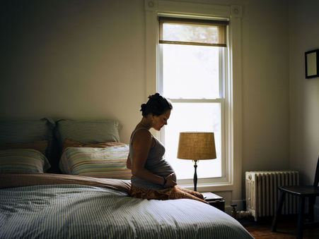 A mother contemplating the unexpected challenges that come along with pregnancy.