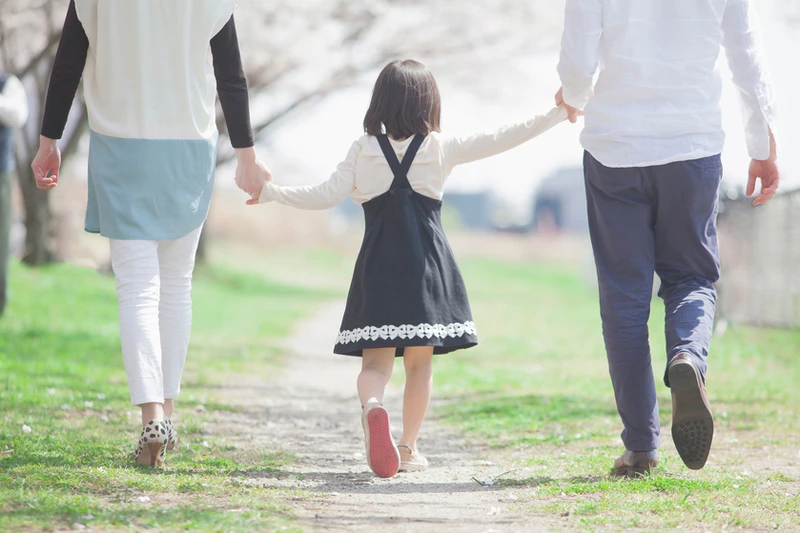 Daughter walking with parents