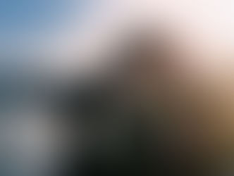 Photographer at sea taking landscape photograph.