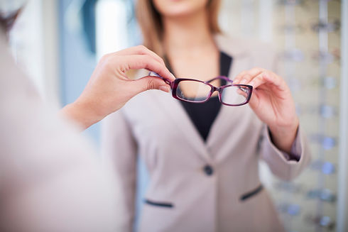 Woman at the optician trying on glasses