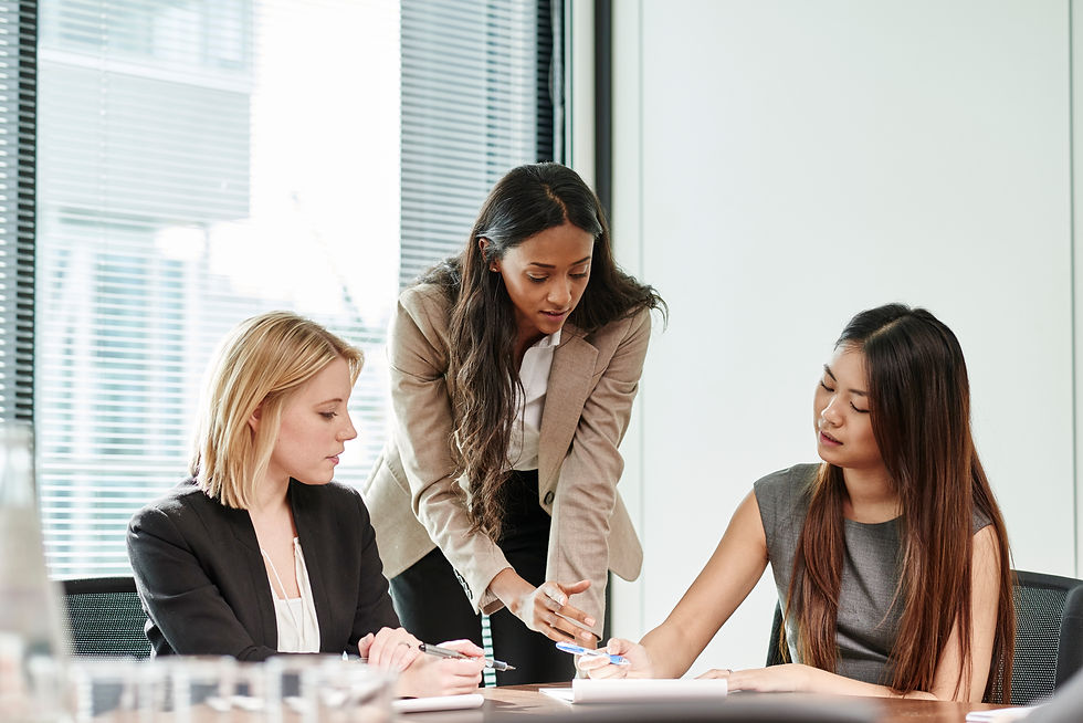Three women engaged in a consultation or collaborative discussion
