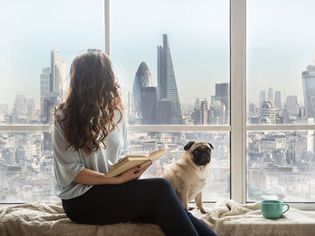 A girl reading to her dog 