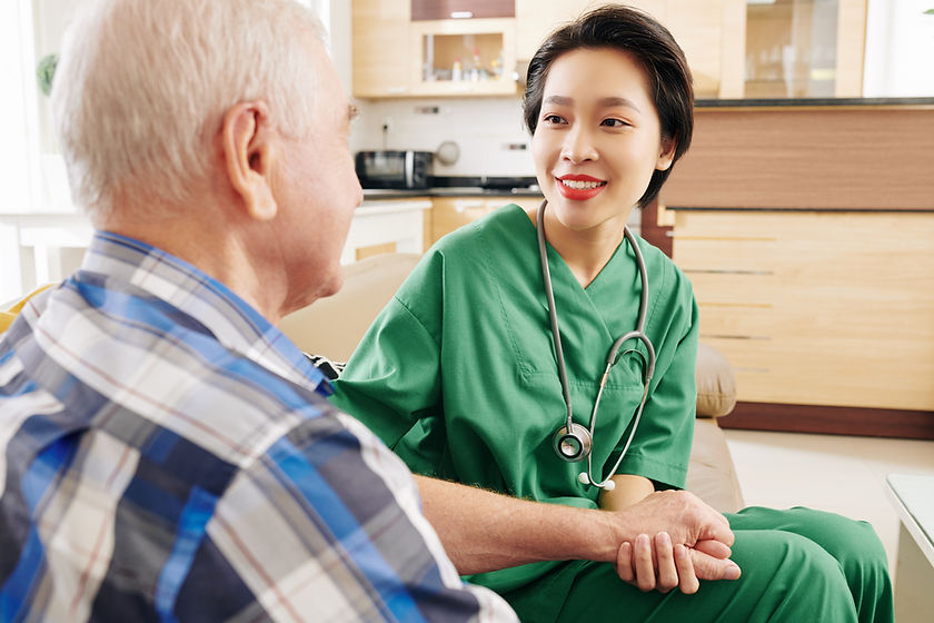 Nurse assisting elderly man