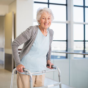 WOMAN USING WALKING FRAME