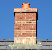 Gray tile roof and chimney on a house