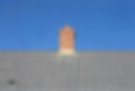 chimney on the roof of a house with blue sky in the background