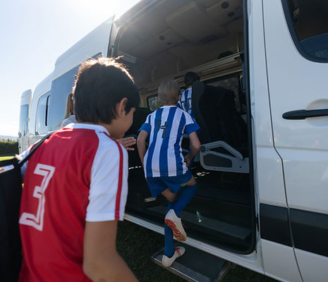 Group of boys getting on the bus to go home