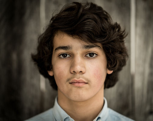 A young boy going through puberty with slight acne around his cheek areas