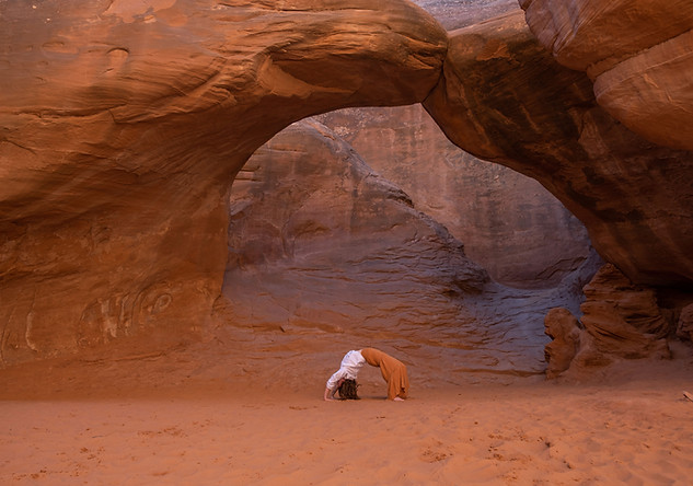 Yoga under sandstone arch
