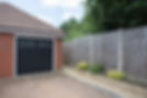 A general exterior view of an outside garage with black doors