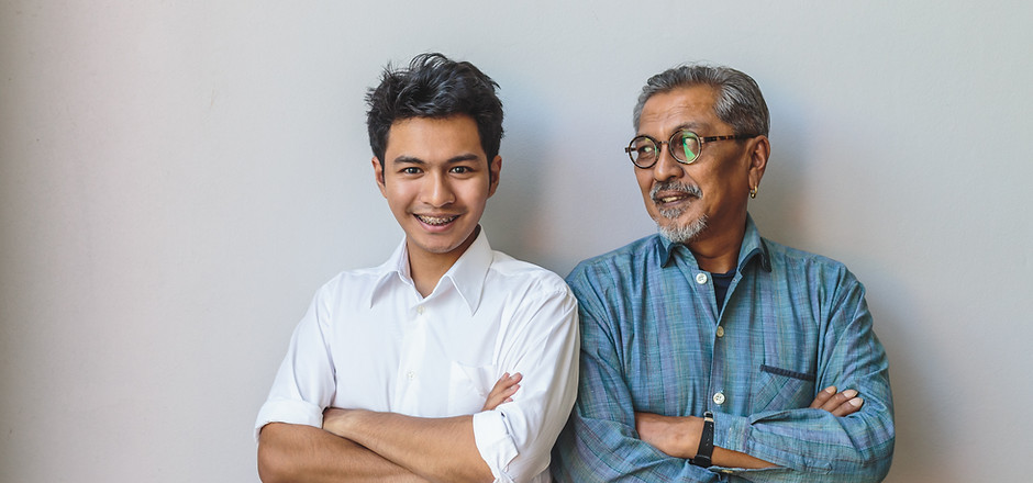 An old man and a young guy standing with arms crossed