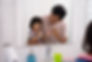 alt="young child and father brushing their teeth in the mirror"