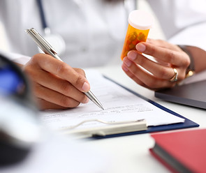 Doctor Holding Prescription