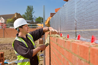 Bricklayer laying brick wall
