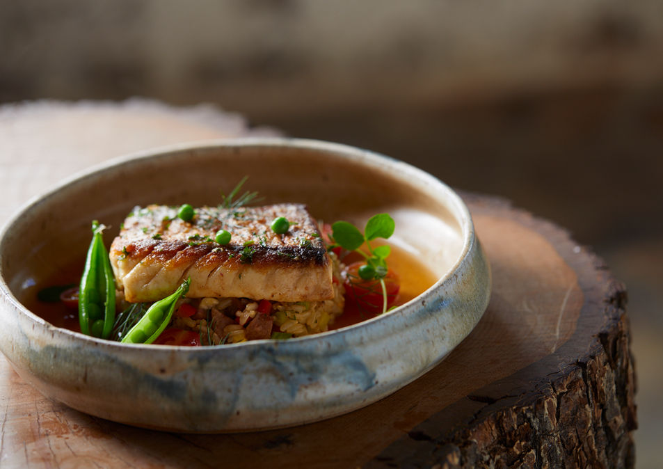 Pan-seared fish with vegetables and herbs.