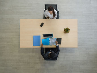Checklist and laptop on a desk used to compare self-service HR systems for a small company