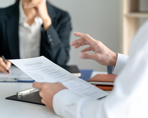 Someone viewing a resume with interviewing a candidate