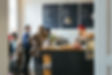 Busy coffee shop with customers waiting to order at counter