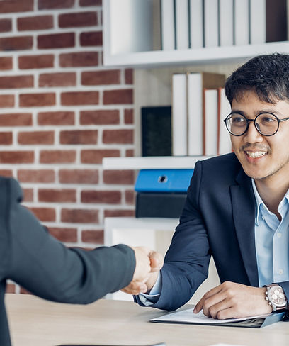 Two people shaking hands at a business meeting.
