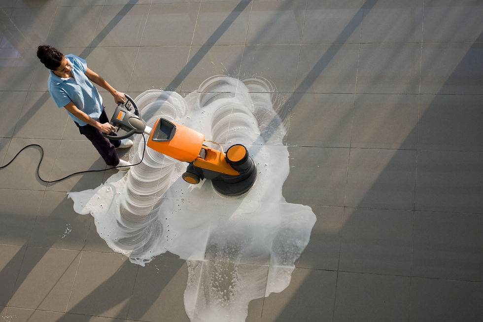 A worker is cleaning the floor with machine