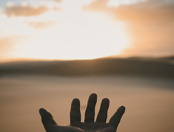 Hand Reaching Sunset