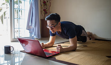 Man planking with laptop