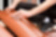 Close-up of a professional installing red tiles
