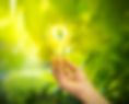 Concept image of sustainability with a light bulb in a person's hand