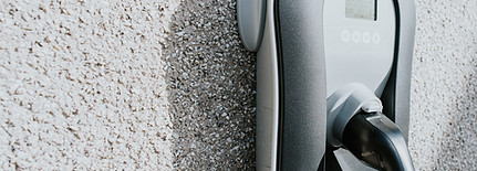 Electric vehicle charging cable connected to a wall mounted home charger