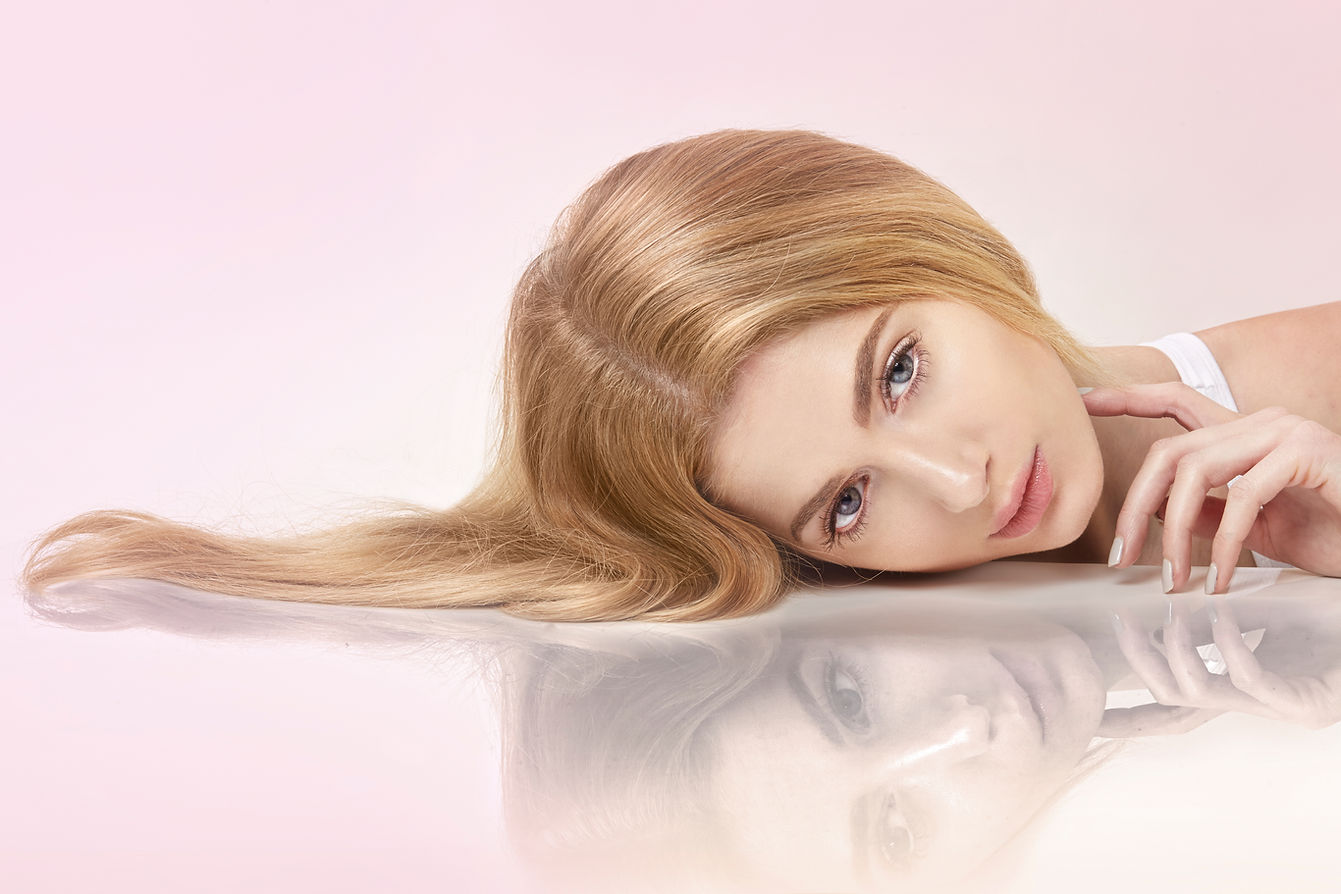 A woman with long blonde hair rests her head sideways