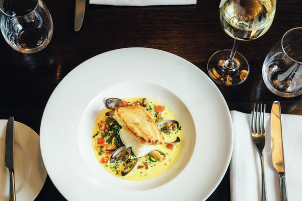 Gourmet fish and shellfish dish with white wine.