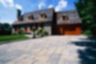 Stone house with landscaped surroundings